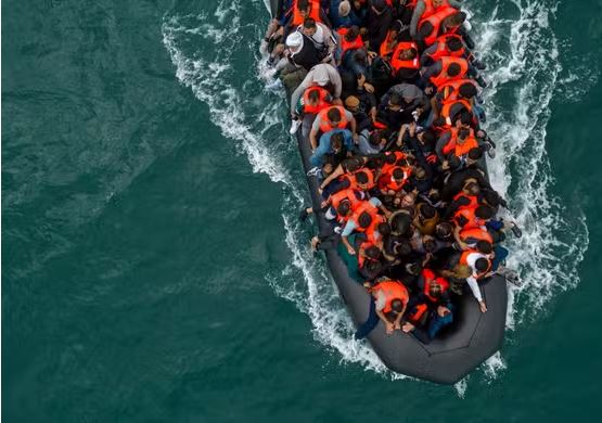 UK says first migrants held under return deal with France
