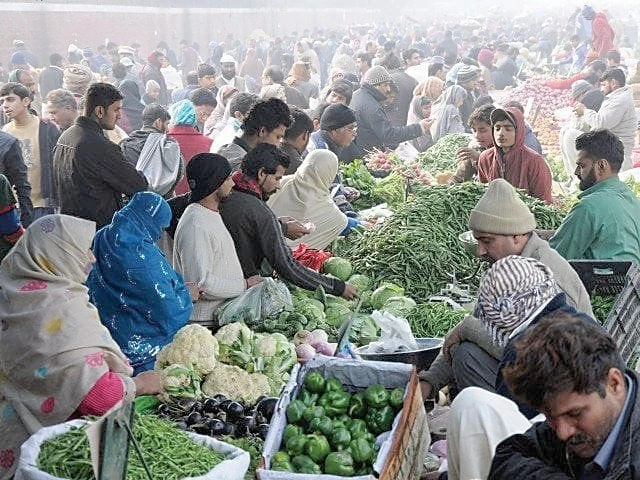 Pakistani shoppers at a vegetable market as onion and tomato prices surge amid inflation driven by Middle East conflict spillover effects