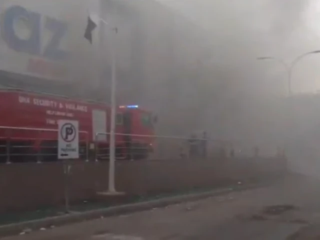 Firefighters work to control the blaze at Imtiaz departmental store on Karachi's Zamzama Street after a fire broke out in the basement early Monday morning.