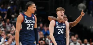 UConn freshman Braylon Mullins celebrates with teammates after hitting the game-winning 3-pointer to defeat Duke and send the Huskies to the Final Four.