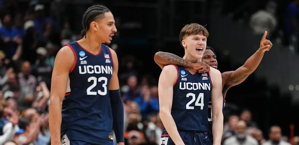 UConn freshman Braylon Mullins celebrates with teammates after hitting the game-winning 3-pointer to defeat Duke and send the Huskies to the Final Four.