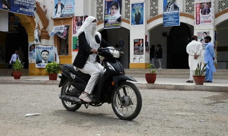 Workers assemble electric motorcycles in Hyderabad as soaring petrol prices and fuel shortage fears drive record sales in Pakistan