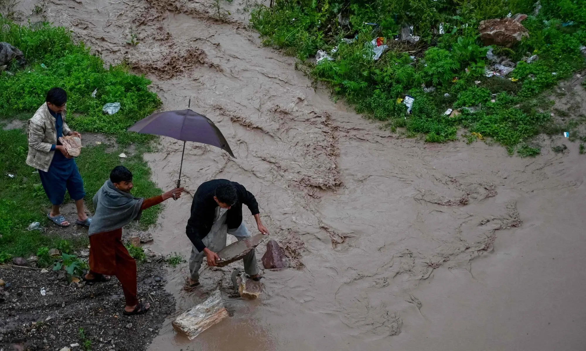 Rescue personnel evacuate residents from flooded Sardar Colony in Peshawar as Budhni nullah reaches high flood level