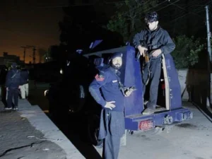 Police personnel at the site of attacks in Bannu where two constables and a security guard were martyred in separate firing incidents.