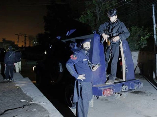 Police personnel at the site of attacks in Bannu where two constables and a security guard were martyred in separate firing incidents.