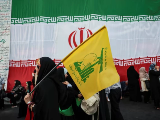 Iranian and Hezbollah flags symbolizing Tehran’s continued support for its Lebanese ally amid regional peace negotiations